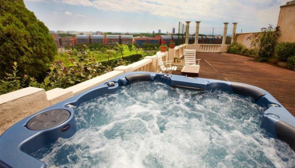 Outdoor spa pool on a large picturesque deck