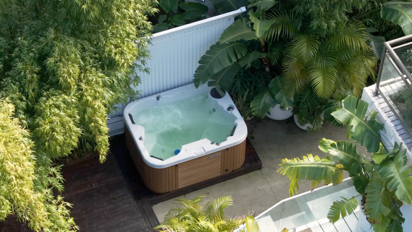 Arial shot of outdoor spa pool in a leafy back yard