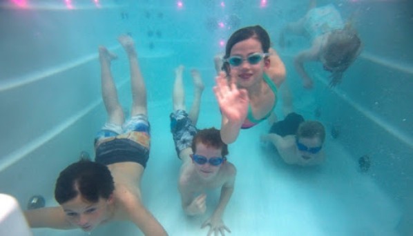 family swimming in spa